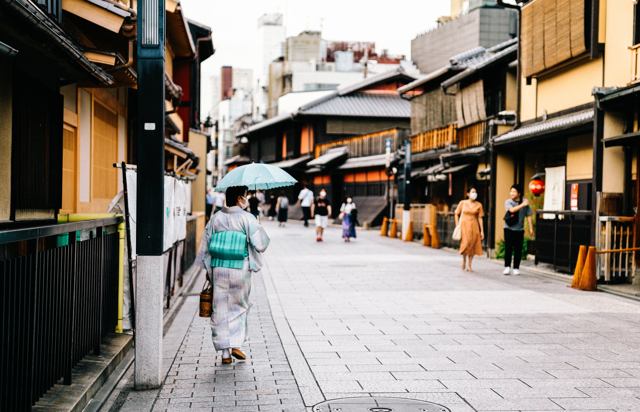 A Woman in Kimono Walking at Street